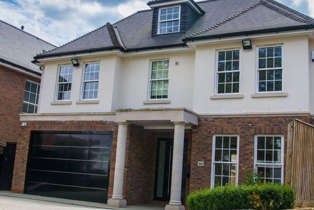 Modern house exterior featuring multiple aluminium sliding sash windows.