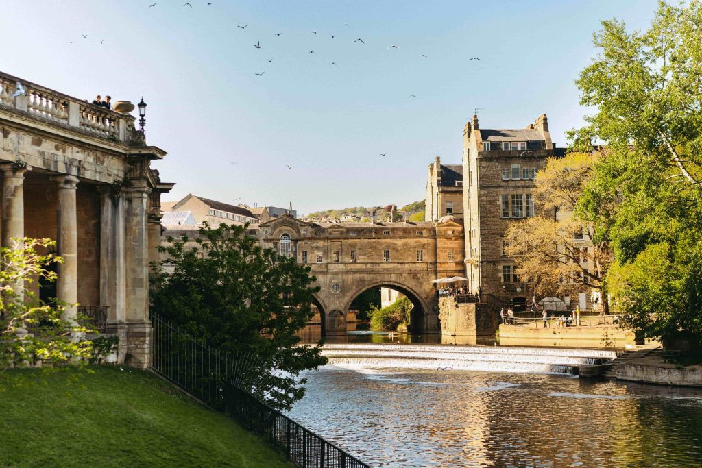 The city of Bath in Somerset. This image shows the Pulteney Bridge, with a view of the river and the bridge itself from opposite. 